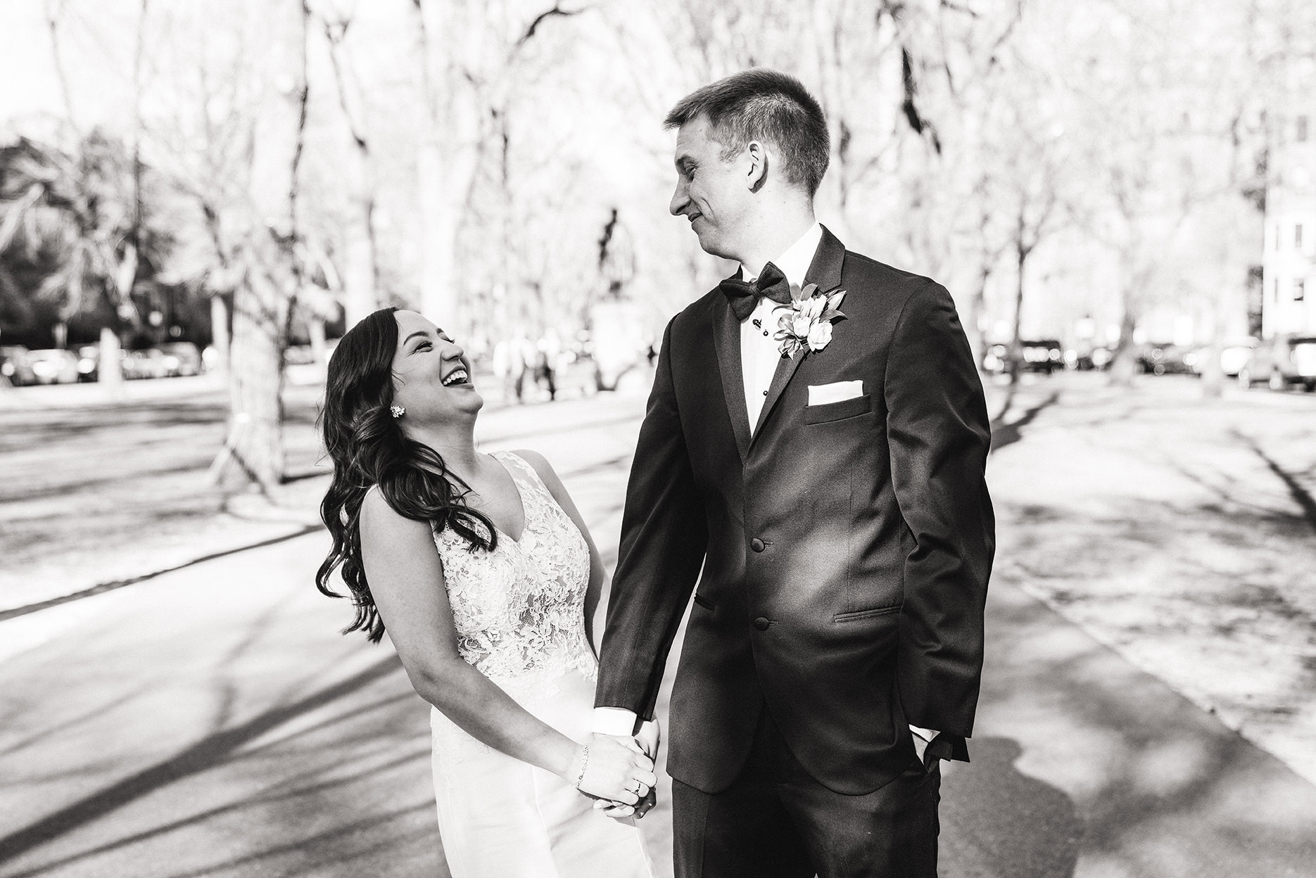 A candid portrait of a bride and groom on commonwealth mall in boston during their fairmont copley wedding