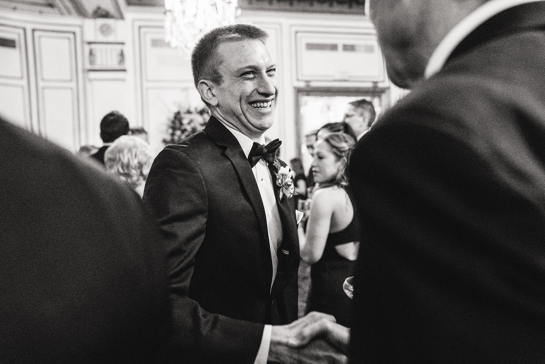 A documentary photograph of guests talking during cocktail hour of a fairmont copley wedding