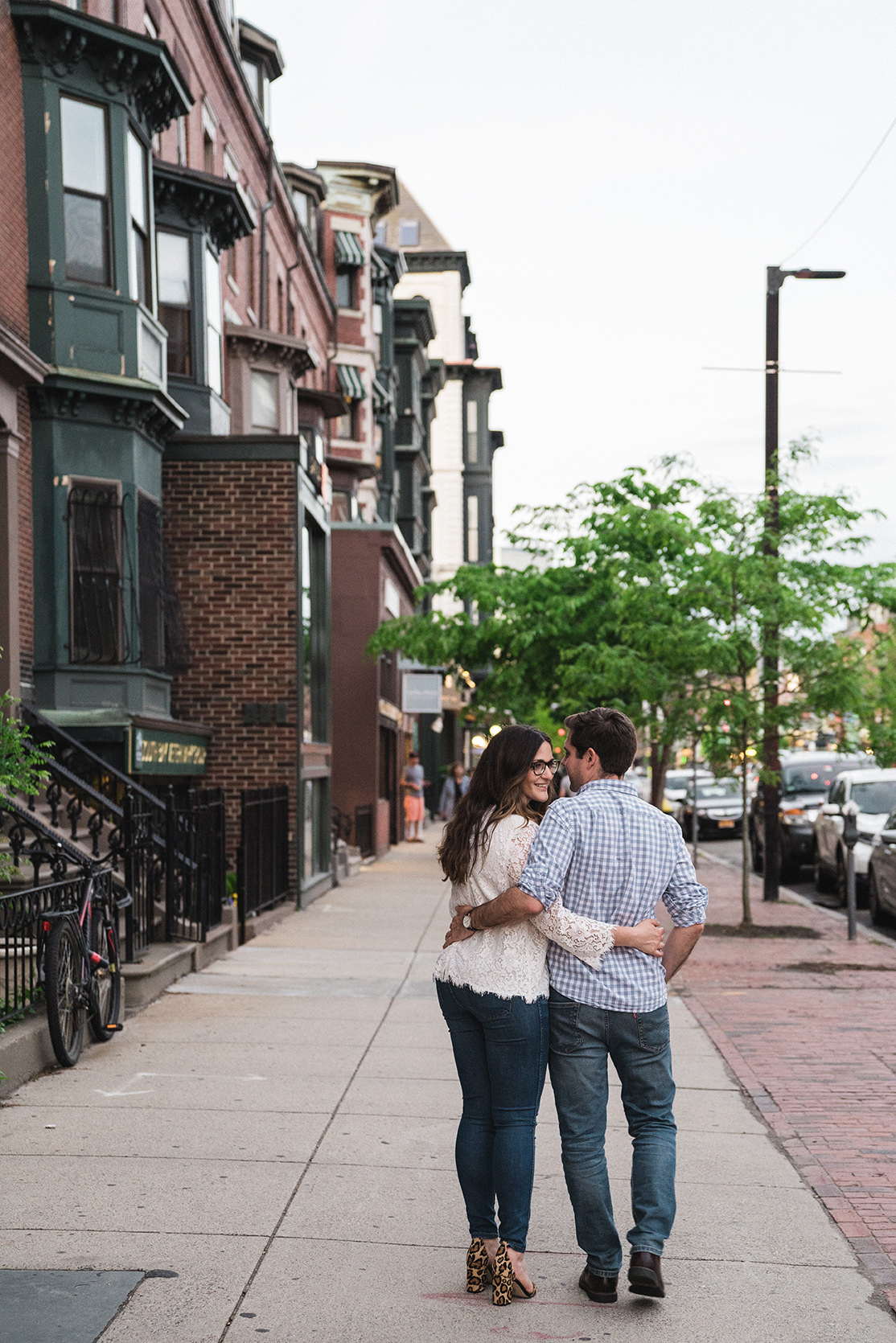 A documentary photograph of a couple walking during their South End Boston Engagement Session