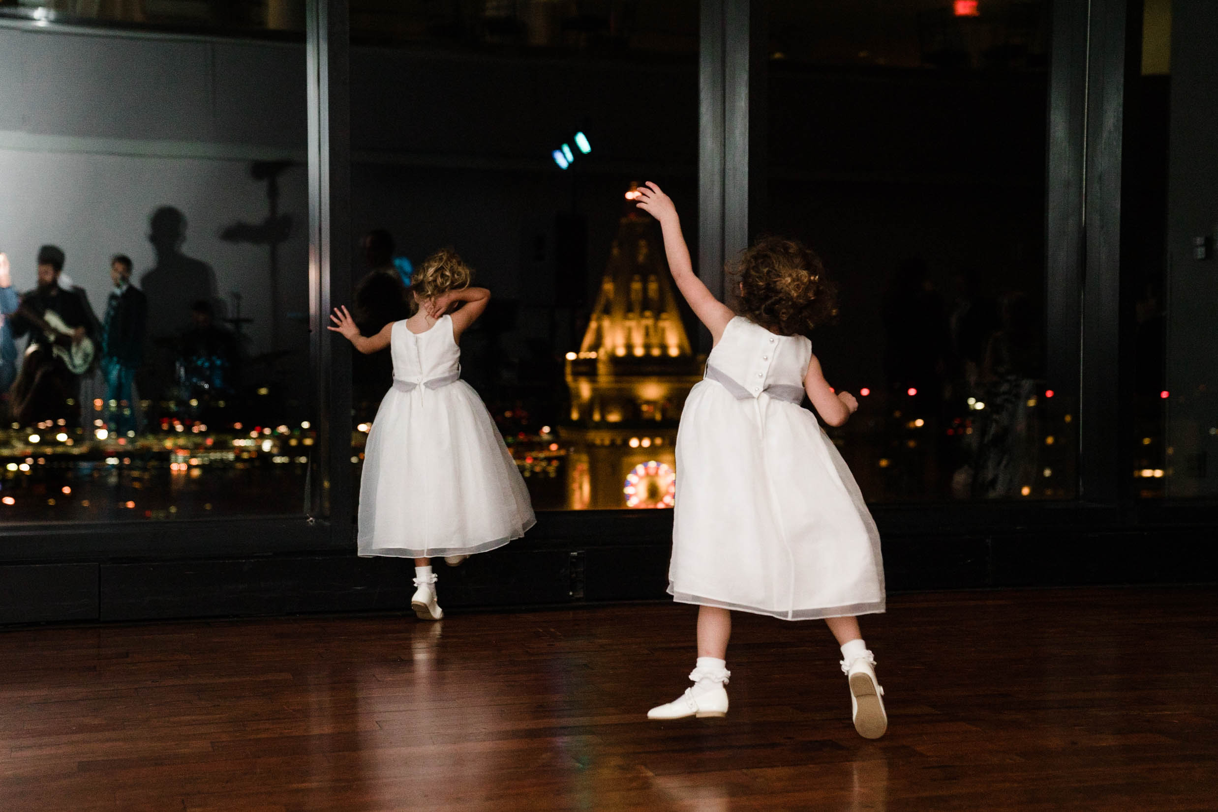 A best of Boston wedding photograph of two flower girls dancing during a State Room wedding