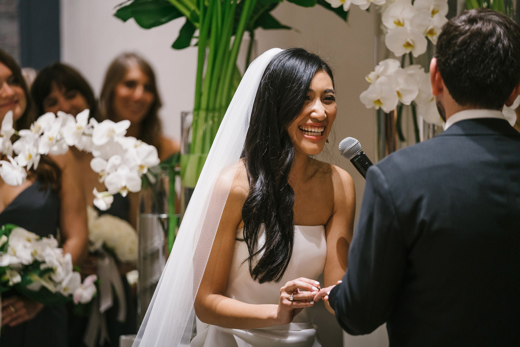 A best of Boston wedding photograph of a bride laughing during her commonwealth wedding ceremony in Boston