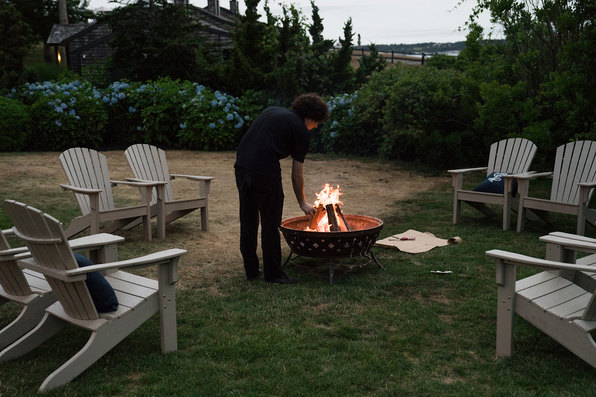 A best of Boston wedding photograph of a fire pit being lit for a Castle Hill Inn wedding reception