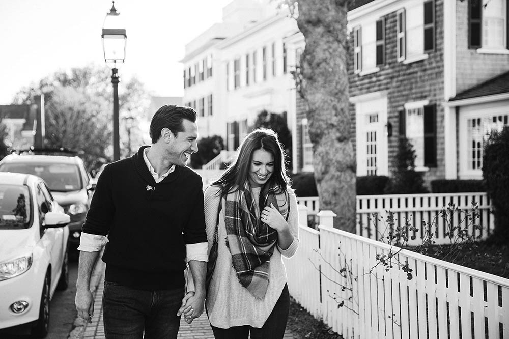A documentary portrait of a couple walking and laughing together during their engagement session on Martha's Vineyard