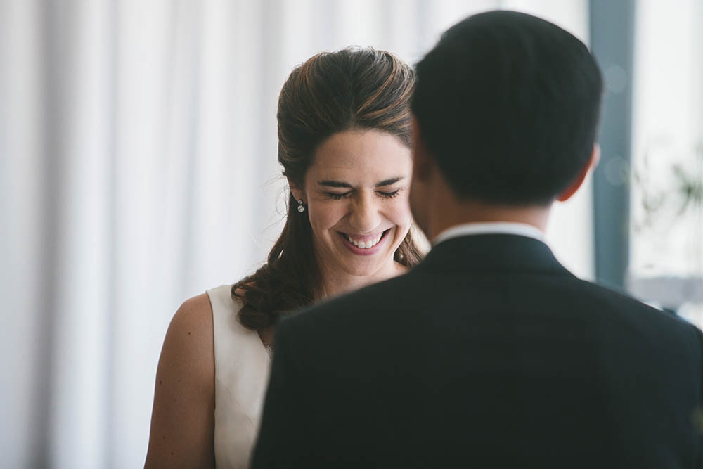A documentary photograph of bride saying her vows during an Artists For Humanity Wedding ceremony in Boston
