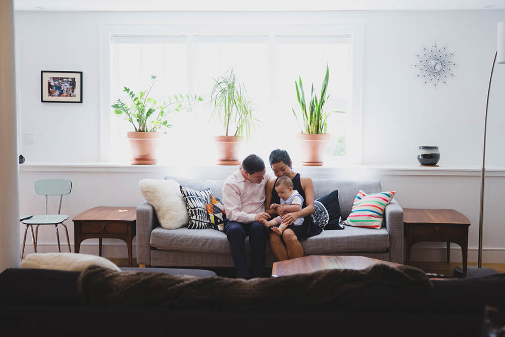 A documentary photograph of a family sitting together during their in home family session in Boston's Jamaica Plain