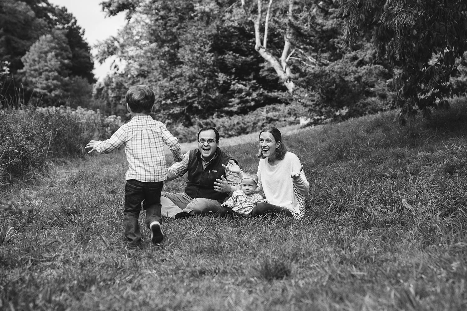 A documentary photograph of a family playing in the Arnold Arboretum during an outdoor lifestyle family session