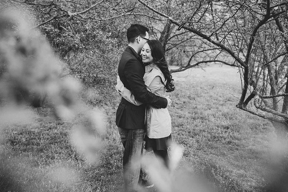 A documentary portrait of a couple hugging during their Larz Anderson engagement session in Boston
