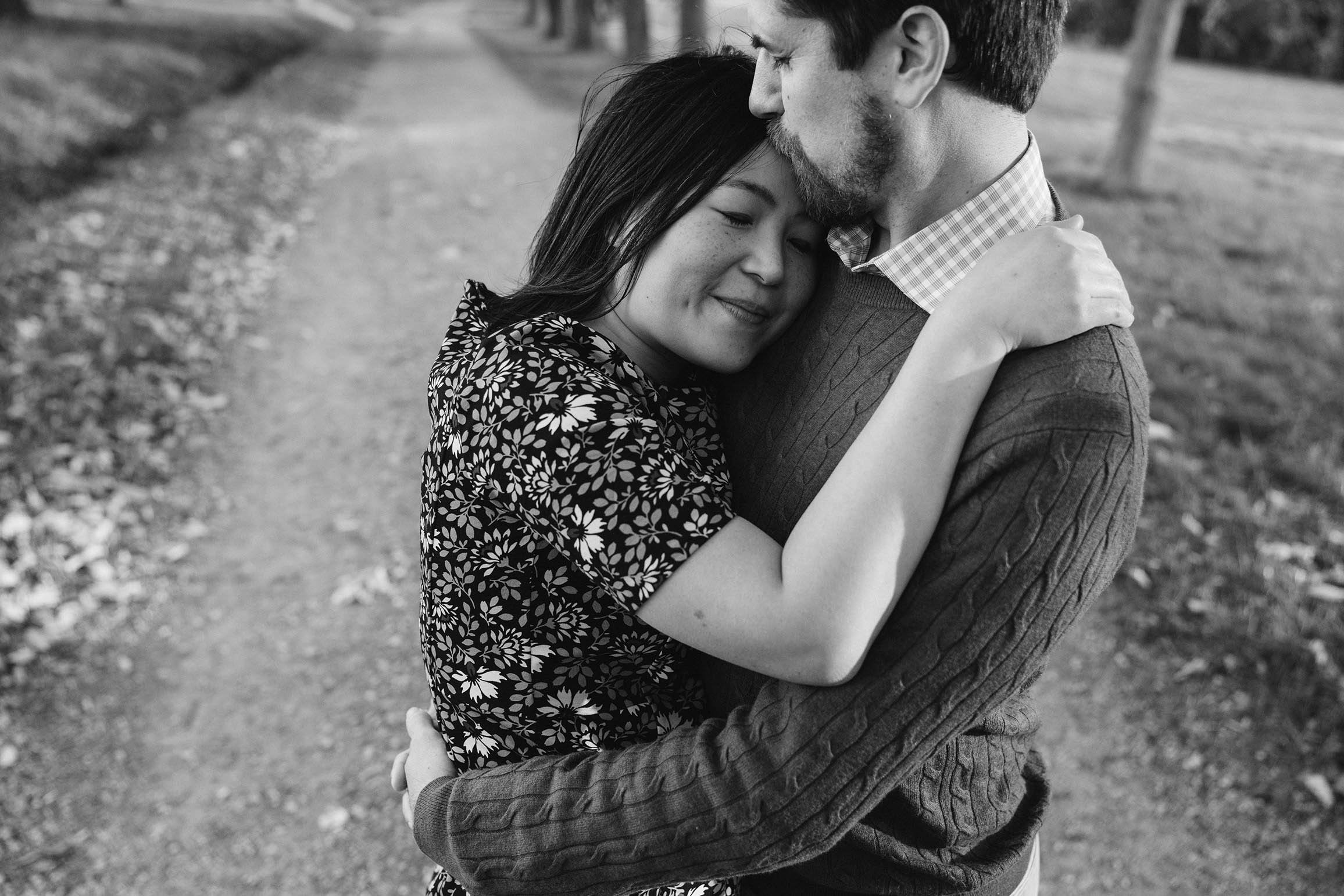 A documentary portrait of a couple hugging and kissing during their world's end engagement session outside of Boston