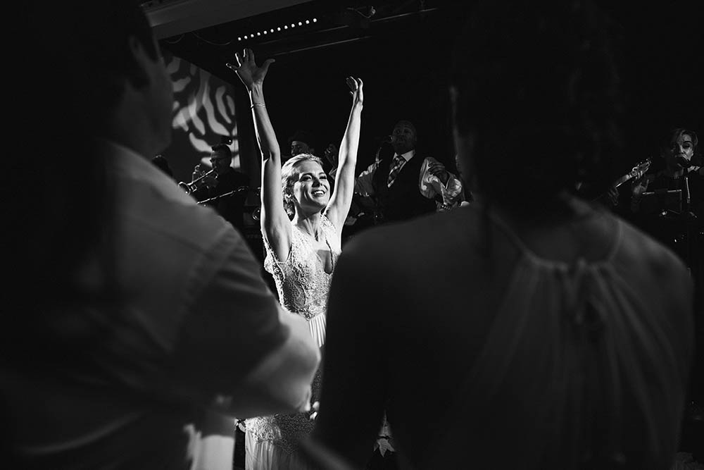 A documentary photograph of a bride dancing at her Boston wedding