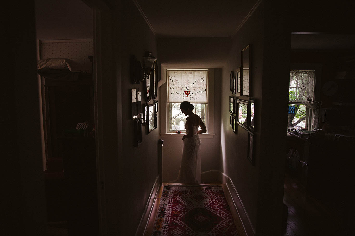 A documentary photograph of bride walking down the stairs after getting ready for her Boston wedding