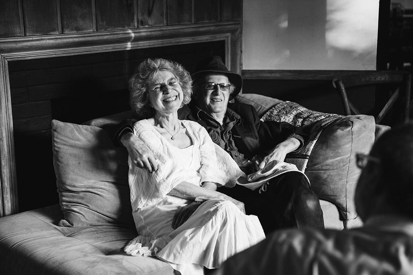 A documentary photograph of grandparents hanging out during an in home Boston wedding