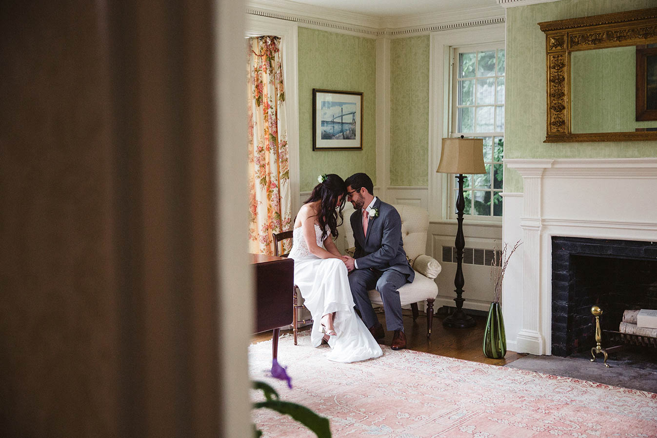 A documentary photograph of a bride and groom sharing an intimate moment before their wedding ceremony in Boston
