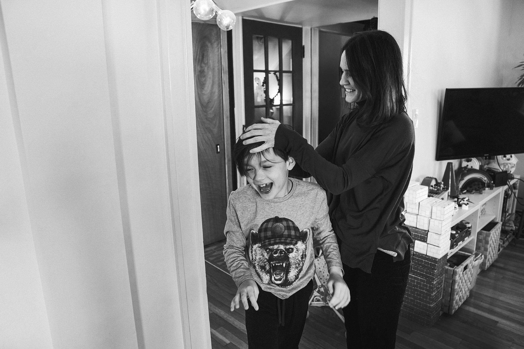 A documentary photograph of a mom and son during an in home family session in Boston's Jamaica Plain