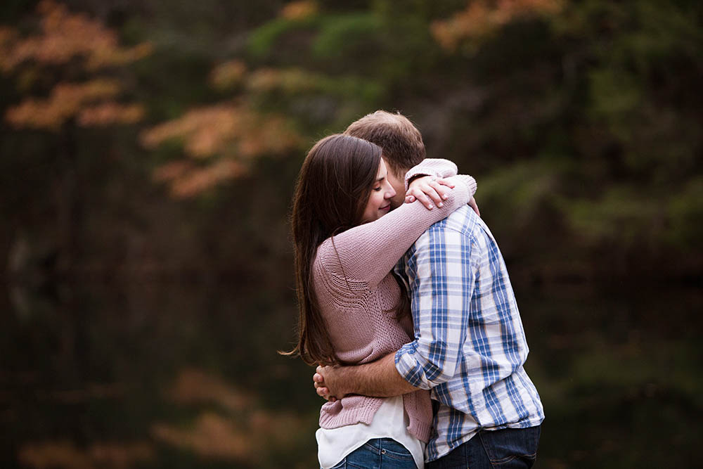 A documentary portrait of a couple hugging during their Boston engagement session