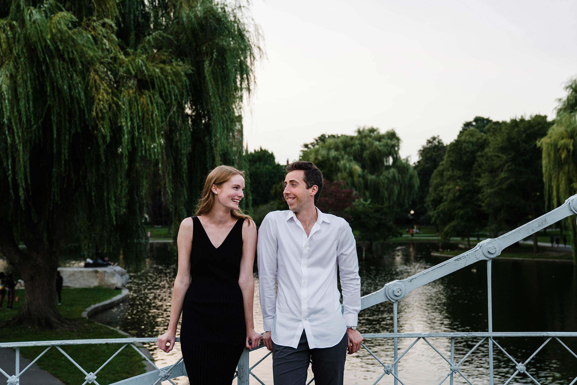A documentary portrait of a couple hanging out at the Boston Public Gardens during their engagement session