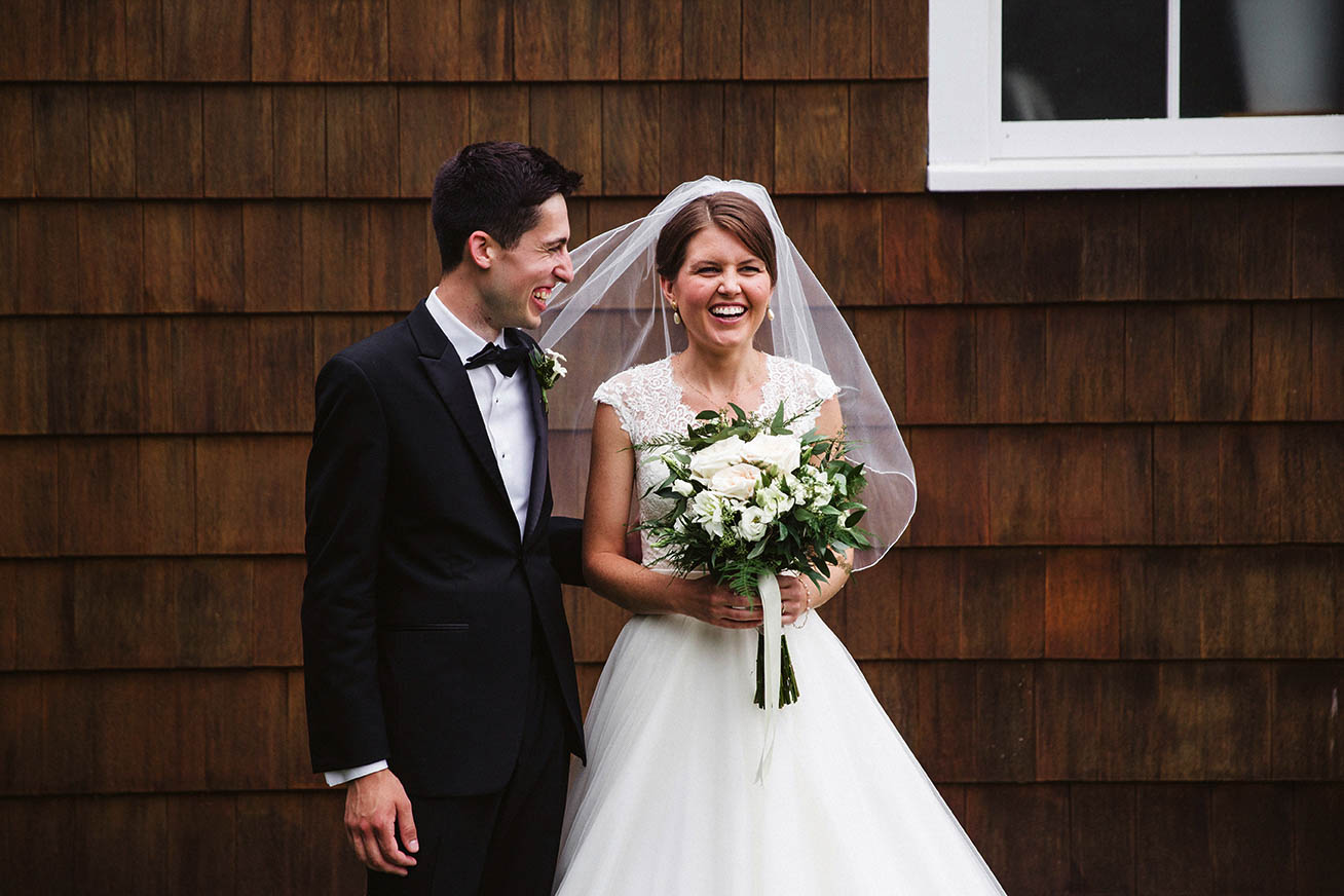 A documentary wedding portrait of a couple laughing after their Boston wedding ceremony