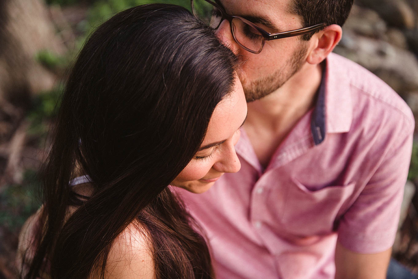 A documentary portrait of a couple hugging at the World's End during their Boston engagement session