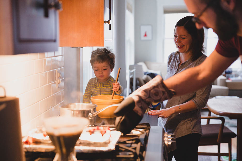 A documentary photograph of family cooking pancakes during their in home family session in Boston