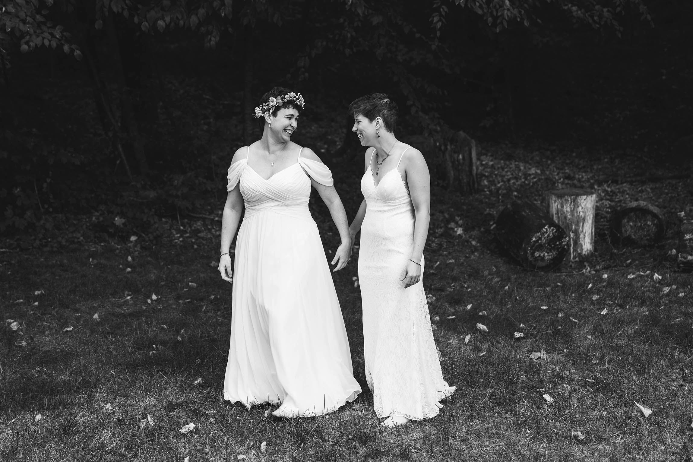 A documentary portrait of two brides laughing and smiling before their Friendly Crossways Wedding outside of Boston