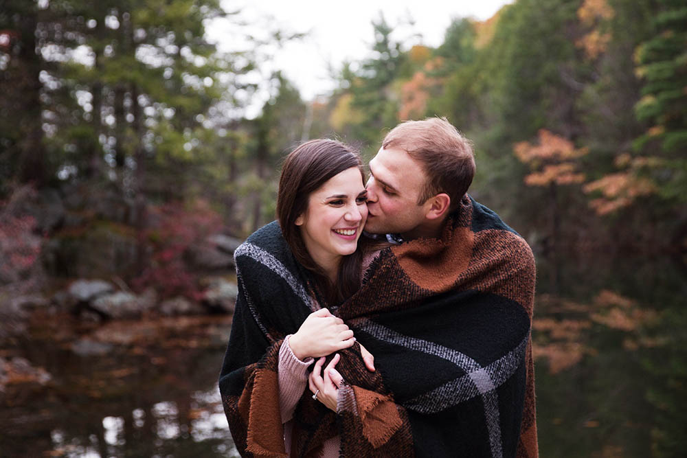 A documentary portrait of a couple hugging at the Arnold Arboretum during their Fall Boston engagement session