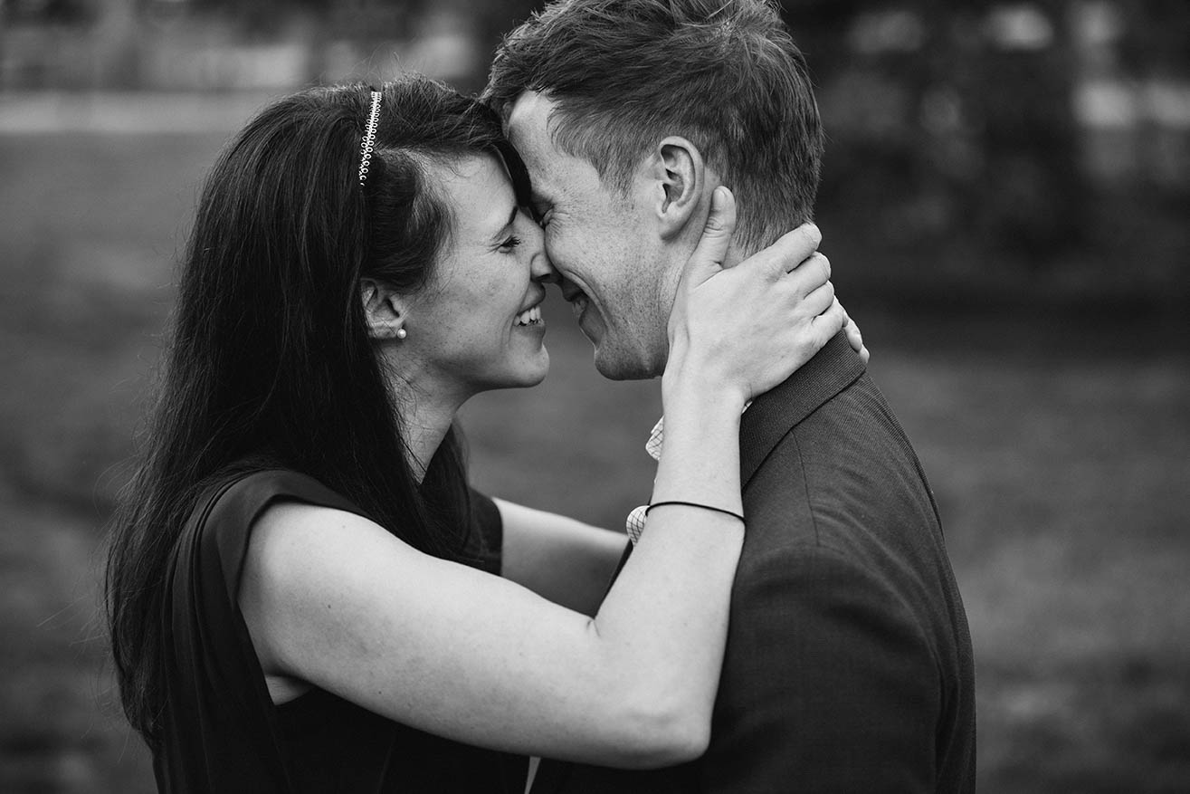 A documentary portrait of a couple hugging at the Public Gardens during their Boston engagement session
