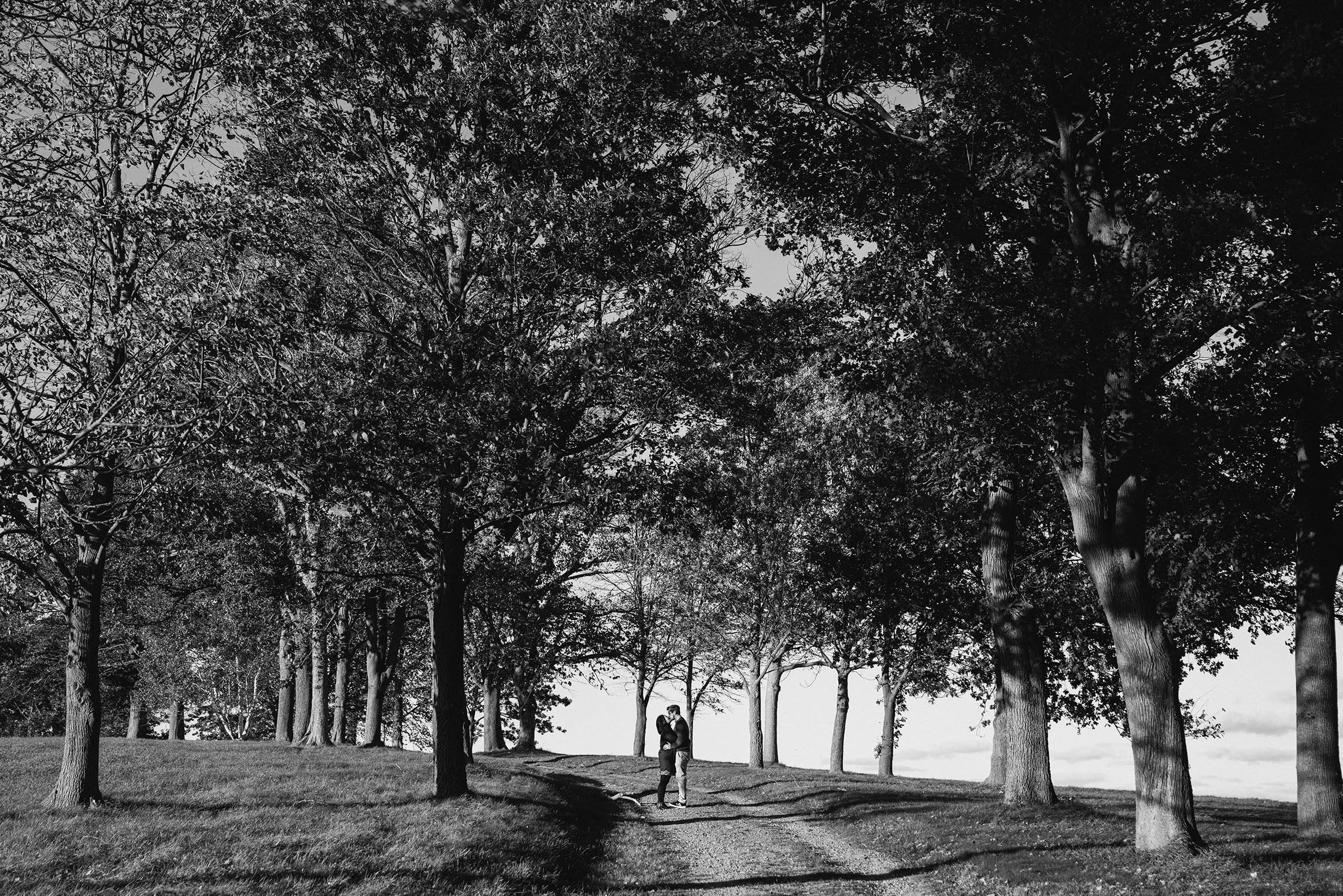 A documentary portrait of a couple hugging at the World's End during their Boston engagement session