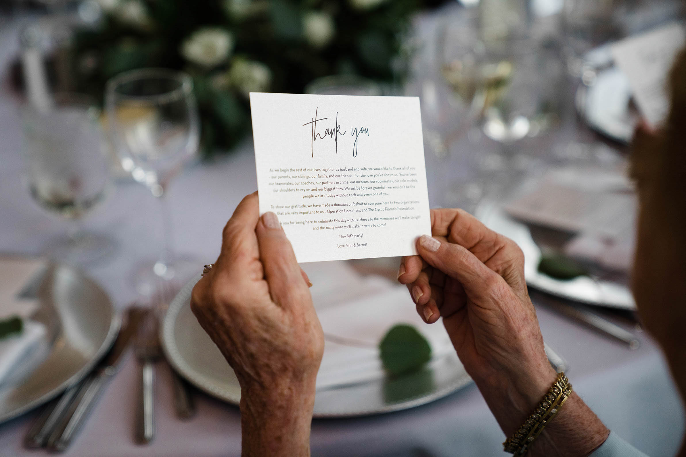 A documentary photograph of a grandmother reading the thank you note at a State Room wedding in Boston
