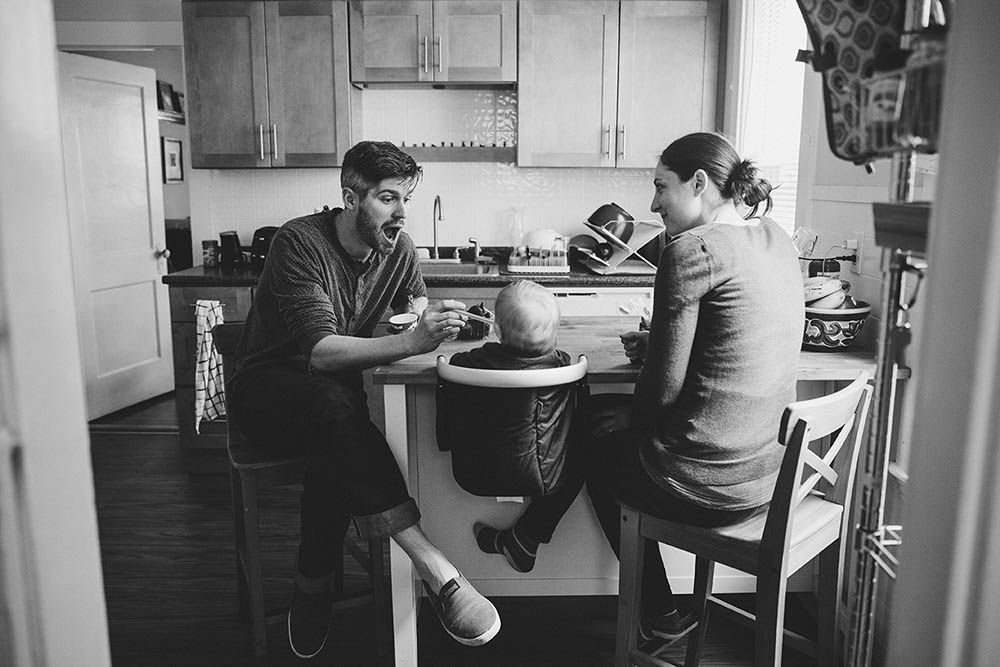 A documentary photograph of a family eating during an in home family session in Boston