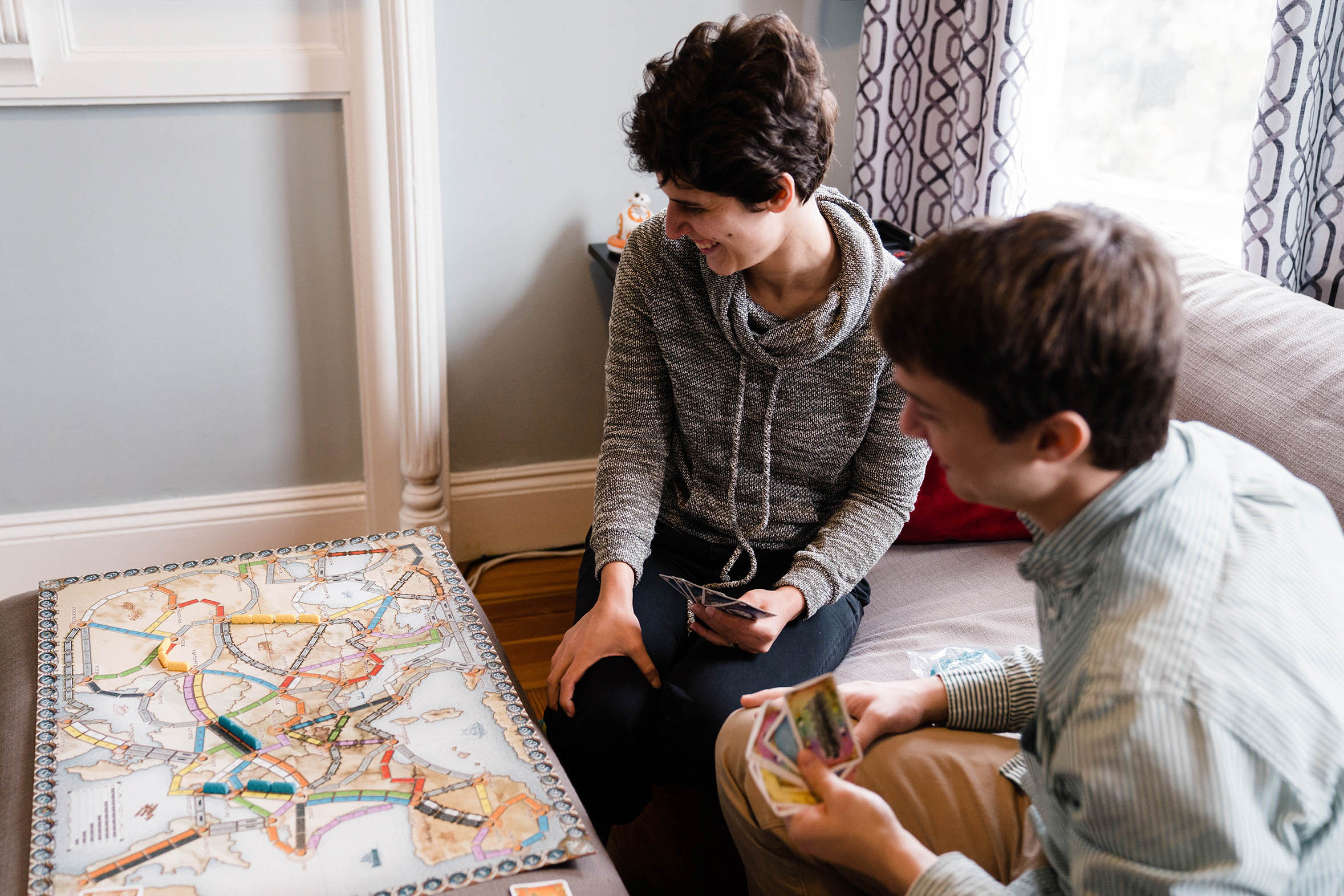 A documentary portrait of a couple playing board games during their Boston couple session at home