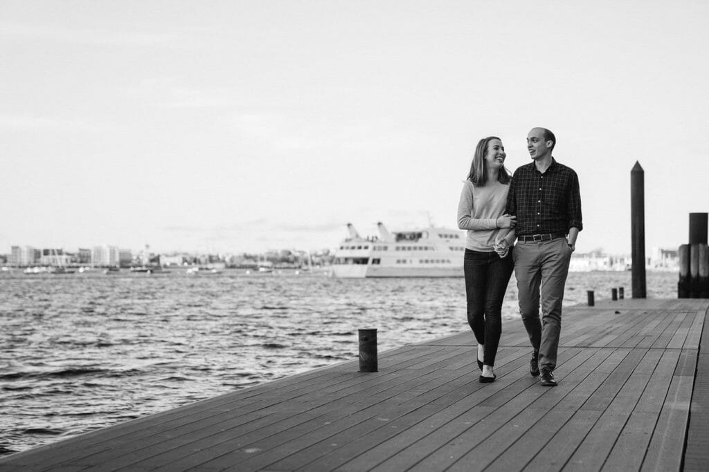 A documentary portrait of a couple walking along Fan Pier during their Boston engagement session