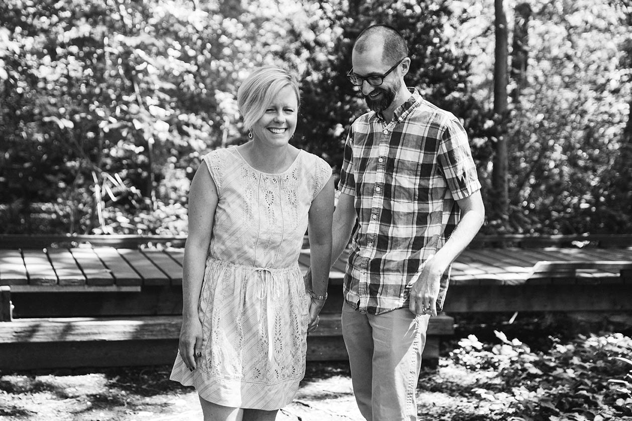 A documentary photograph of parents laughing together during their family session in Boston