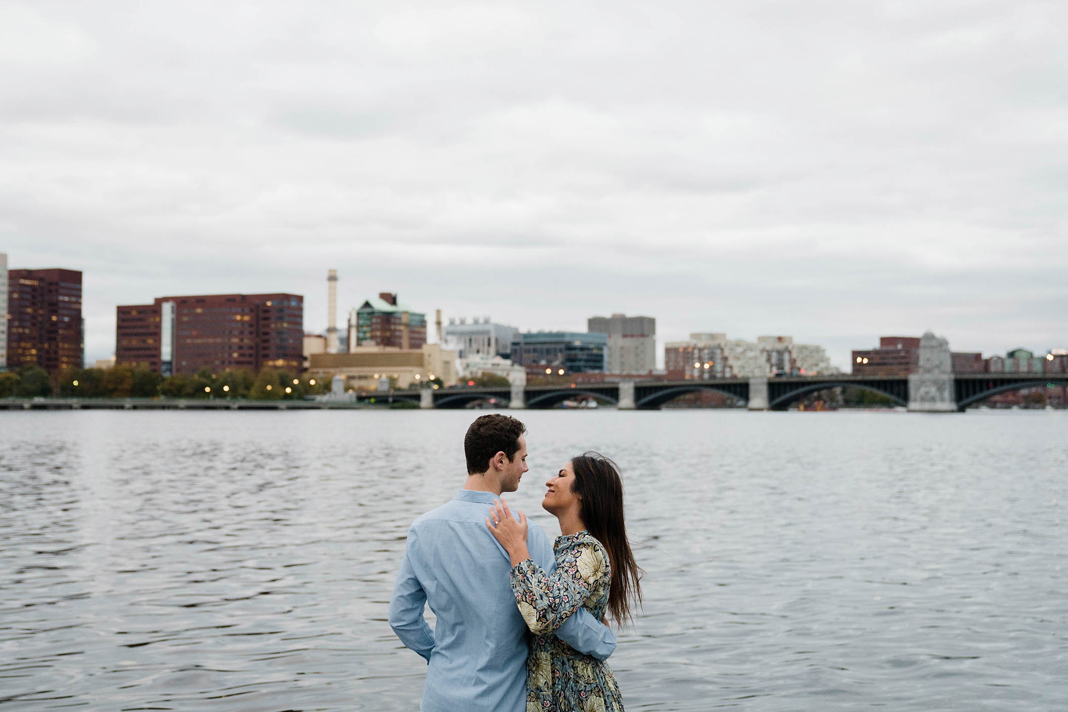 A documentary portrait of a couple hanging out on the Charles River Esplande during their Boston engagement session