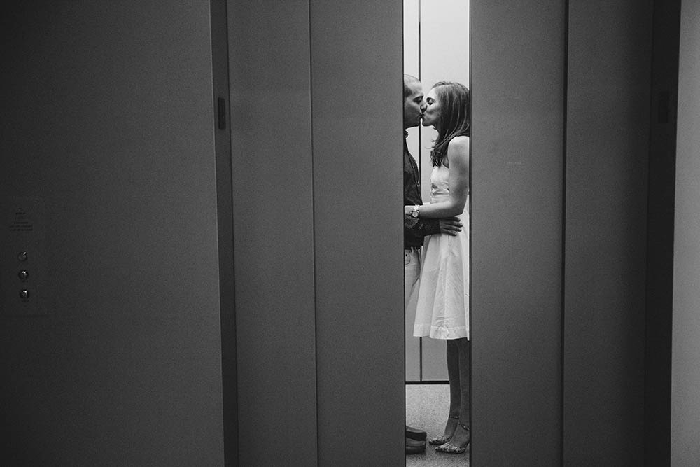 A documentary portrait of a couple kissing on the elevator of the Museum of Fine Art during their Boston engagement session