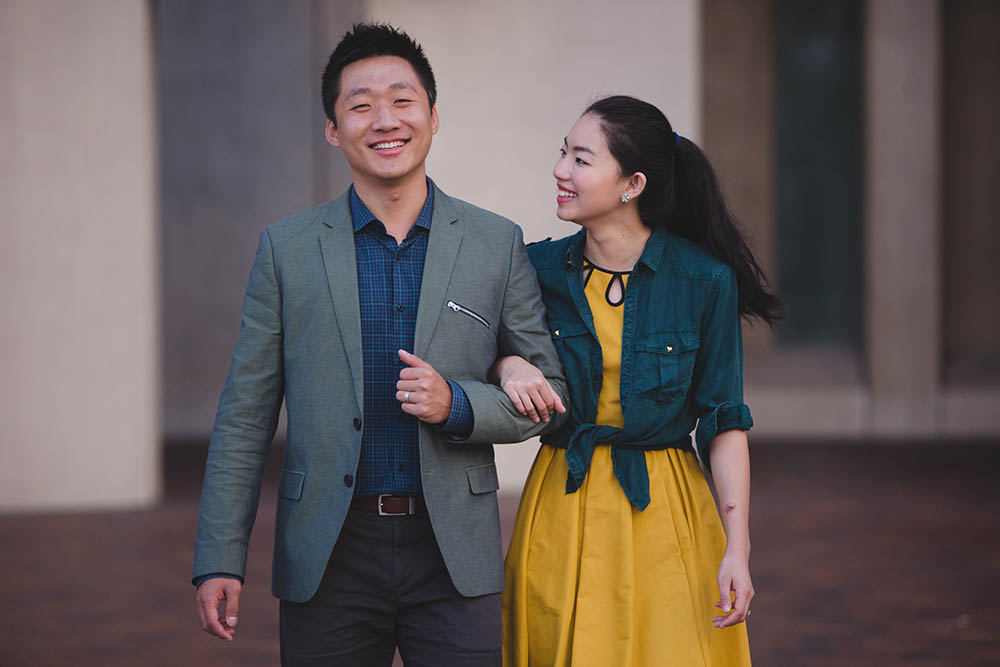A documentary portrait of a couple walking together at the Christian Science Plaza during their Boston engagement session