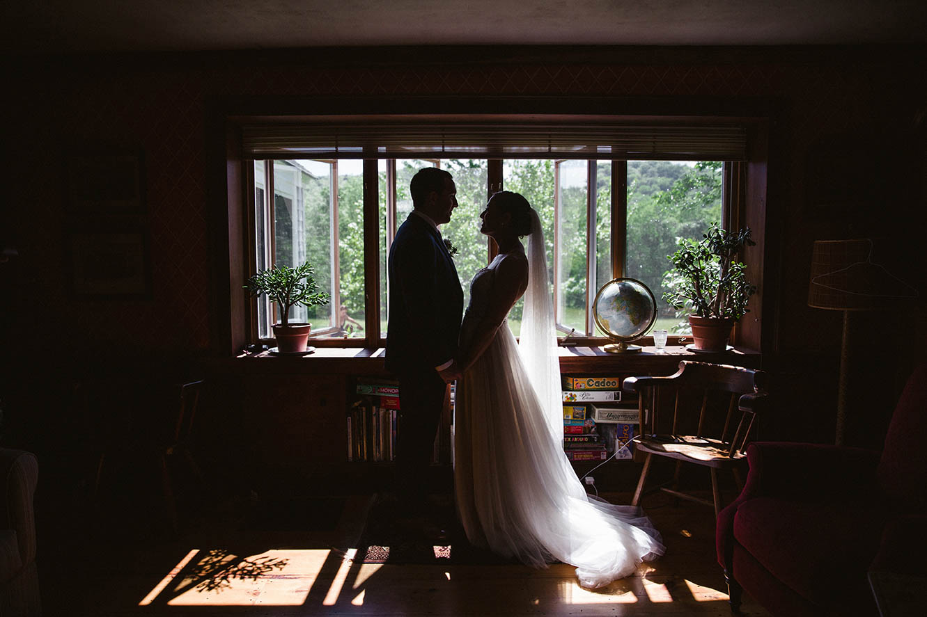 A documentary portrait of a couple sharing an intimate moment before their wedding ceremony at Moody Mountain Farm