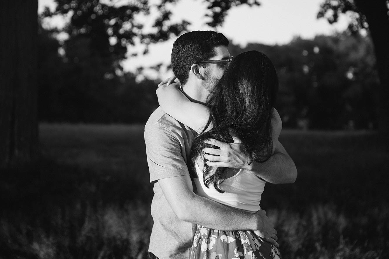 A documentary portrait of a couple hugging at the World's End during their Boston engagement session