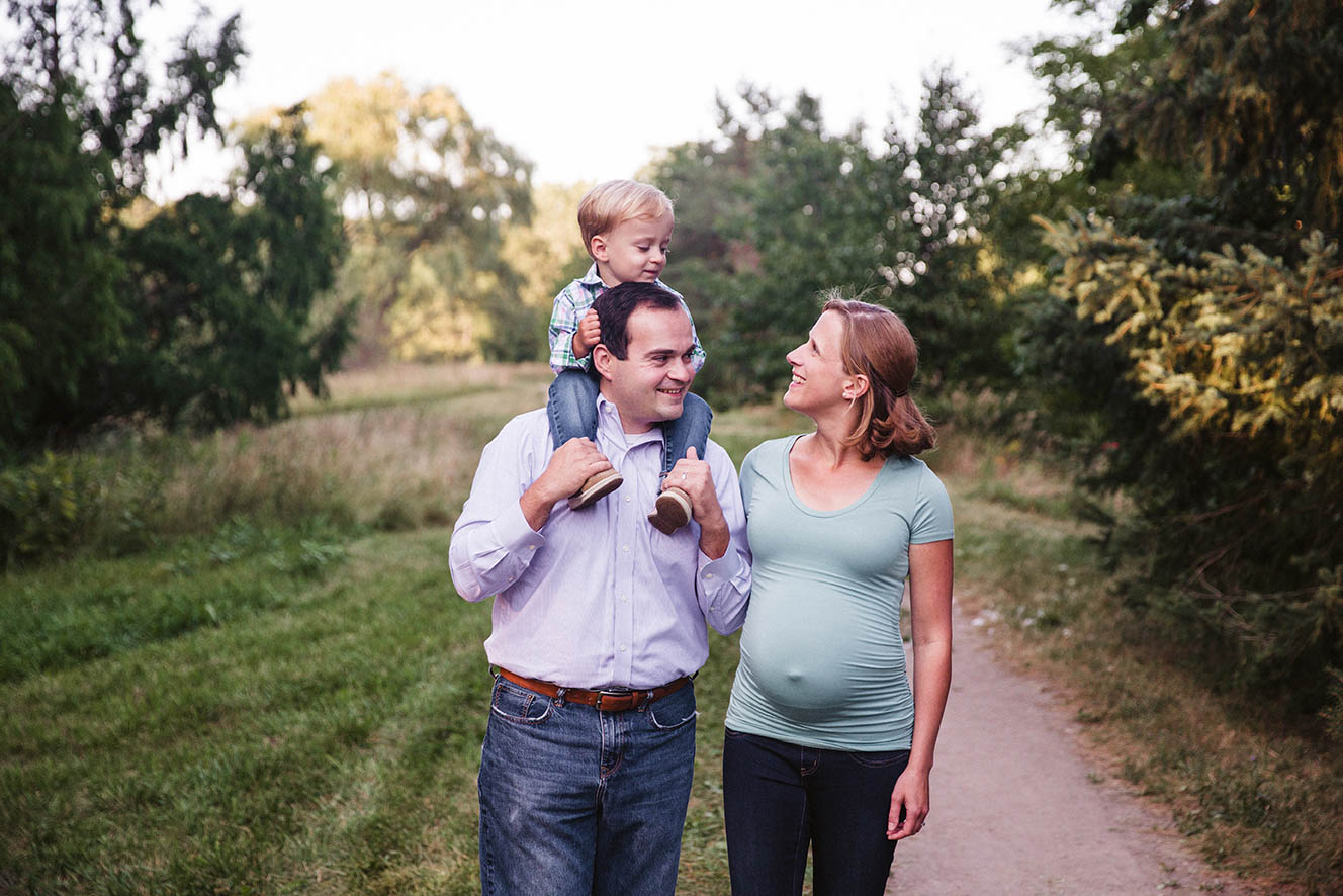 A documentary photograph of a family walking through the Arnold Arboretum during their family session in Boston