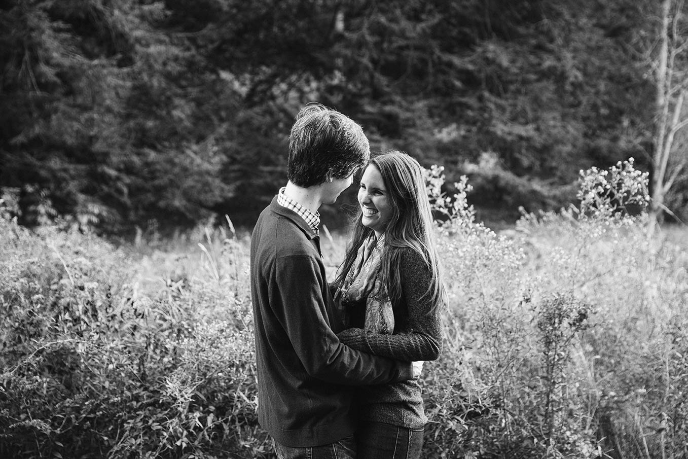 A documentary portrait of a couple hugging at the Arnold Arboretum during their Boston engagement session