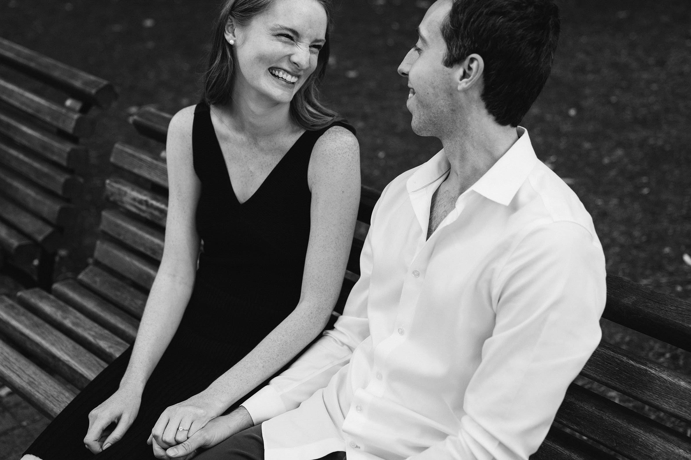 A documentary portrait of a couple hanging out on a bench at the Public Gardens during their Boston engagement session