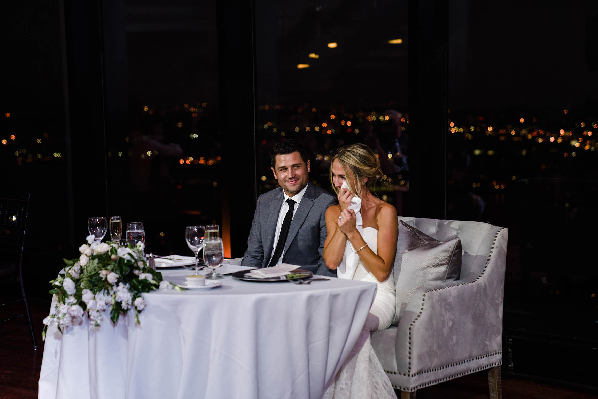 A documentary photograph of bride tearing up at the wedding speeches at her State Room wedding in Boston