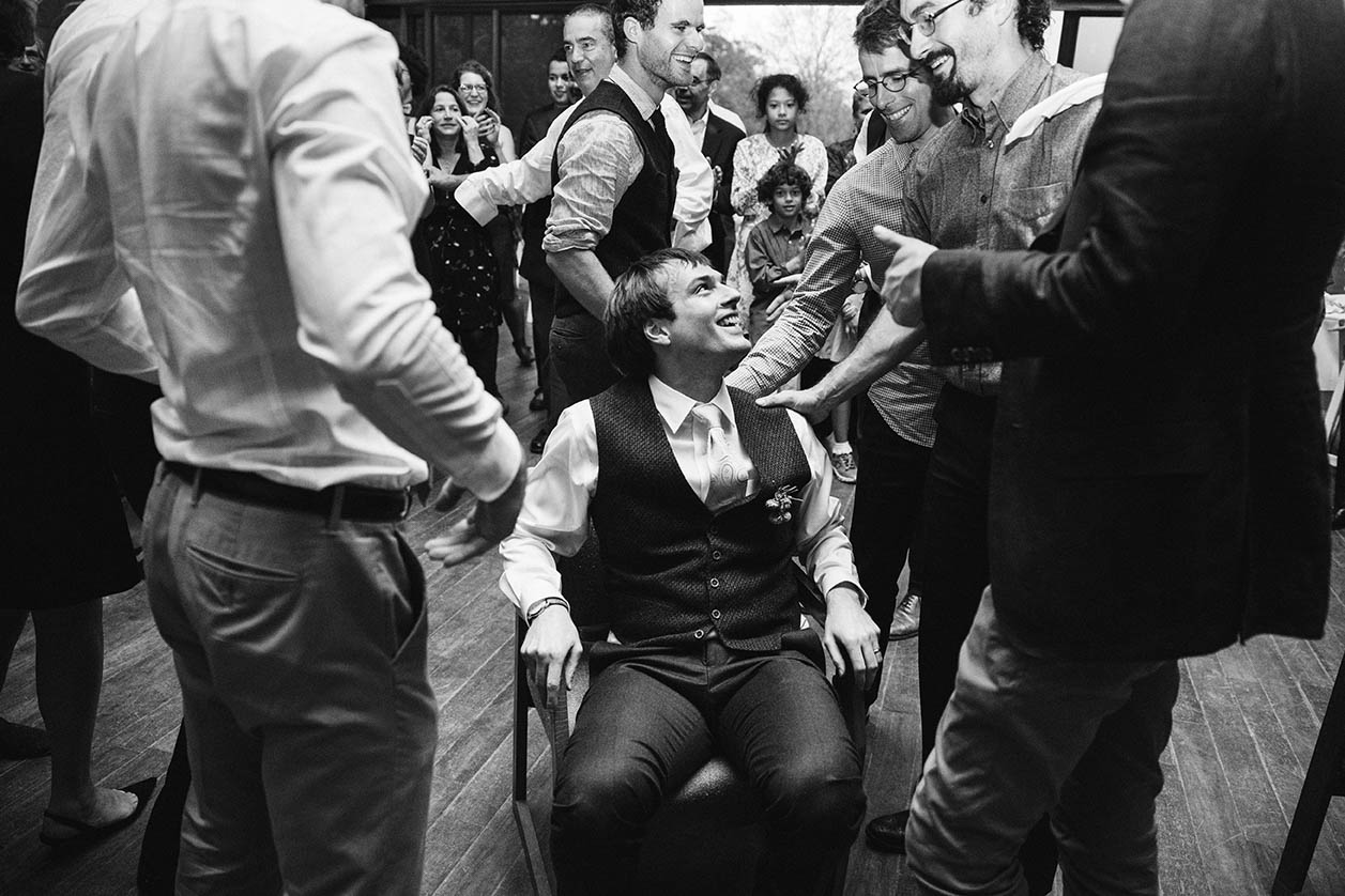 A documentary photograph of a groom before he is lifted up for the horah at his Boston wedding