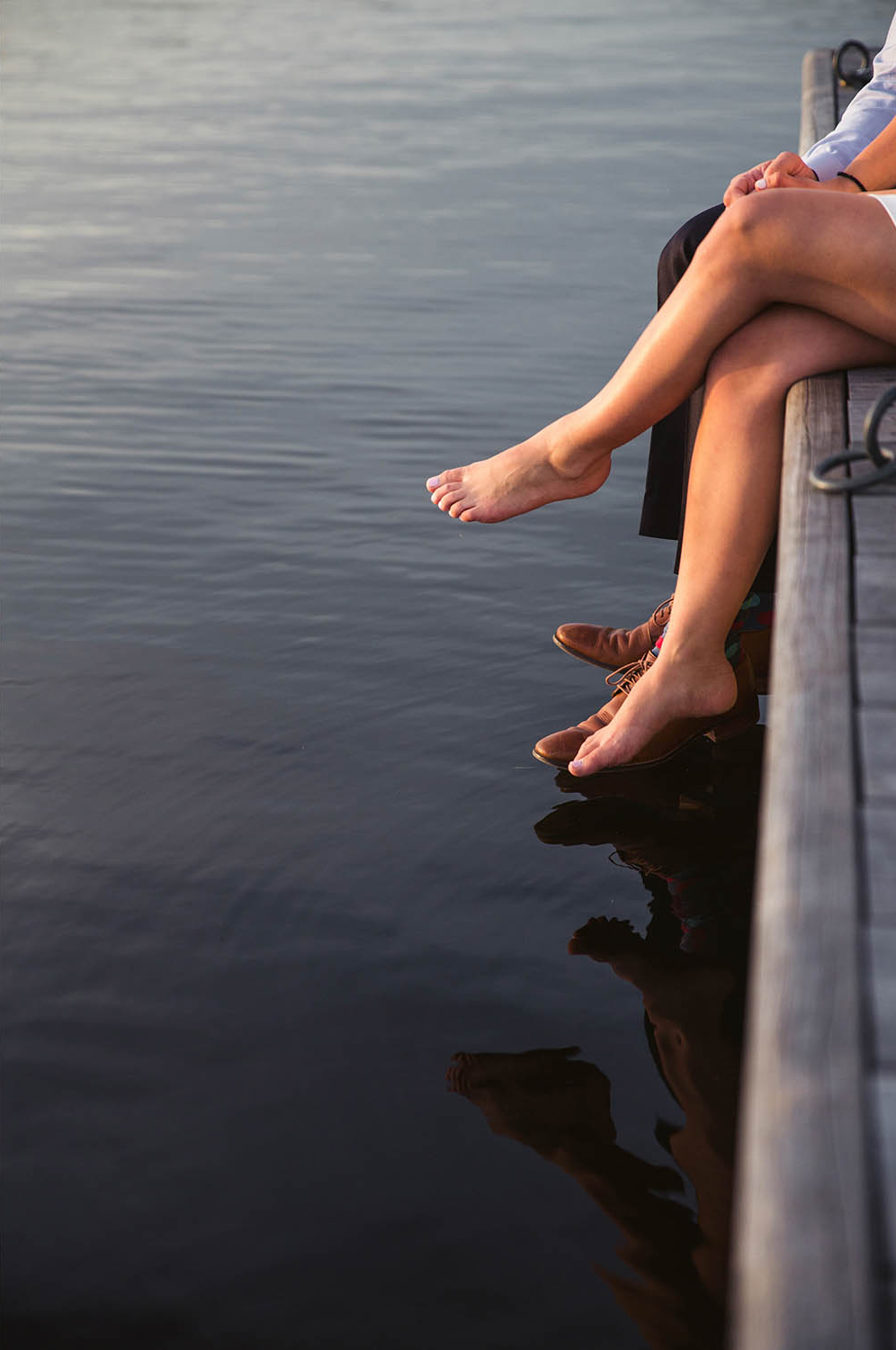 A documentary portrait of a couple hanging out on the Charles River Esplande during their Boston engagement session