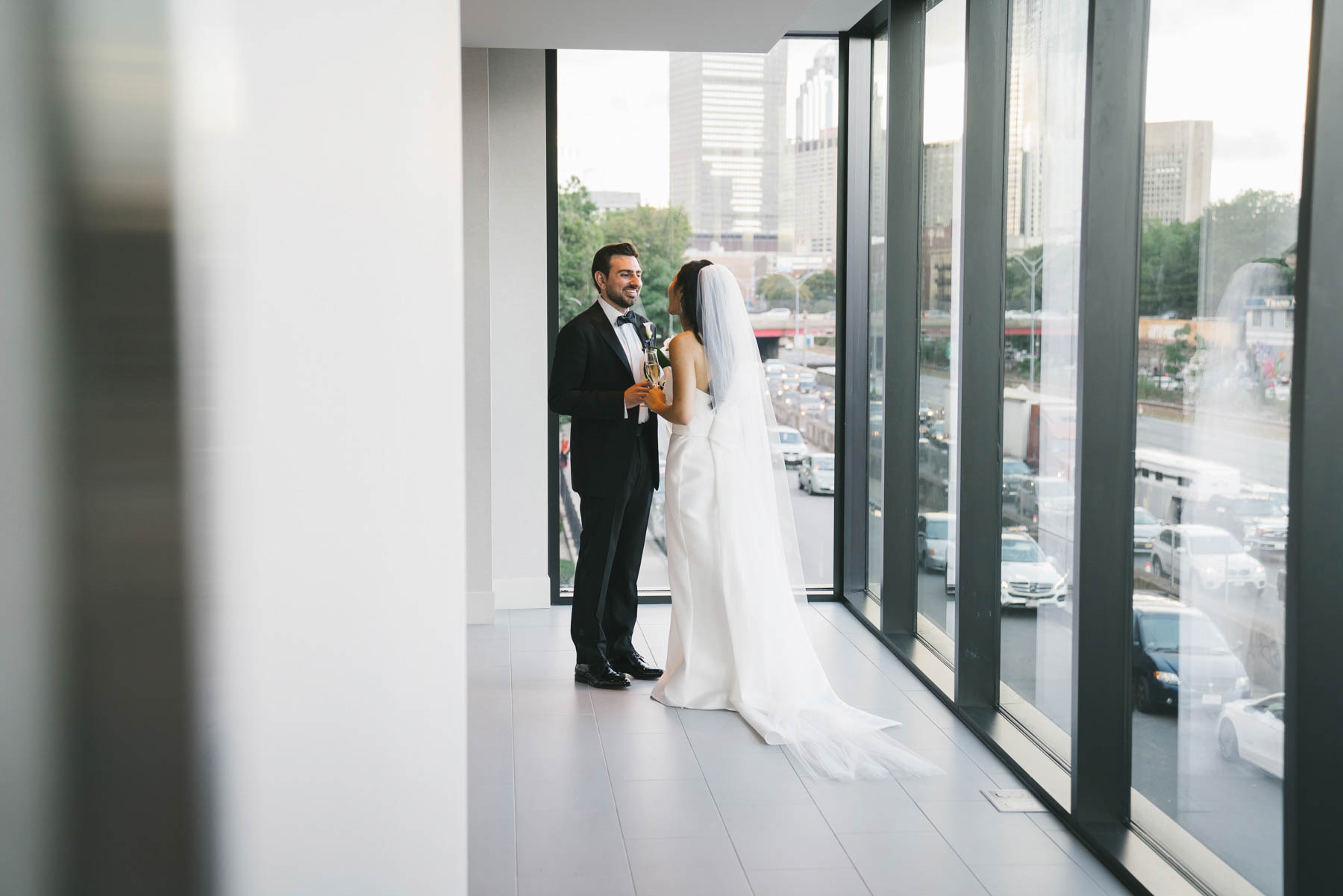 A documentary photograph of a bride and groom sharing an intimate moment after their wedding ceremony at the Commonwealth Hotel in Boston