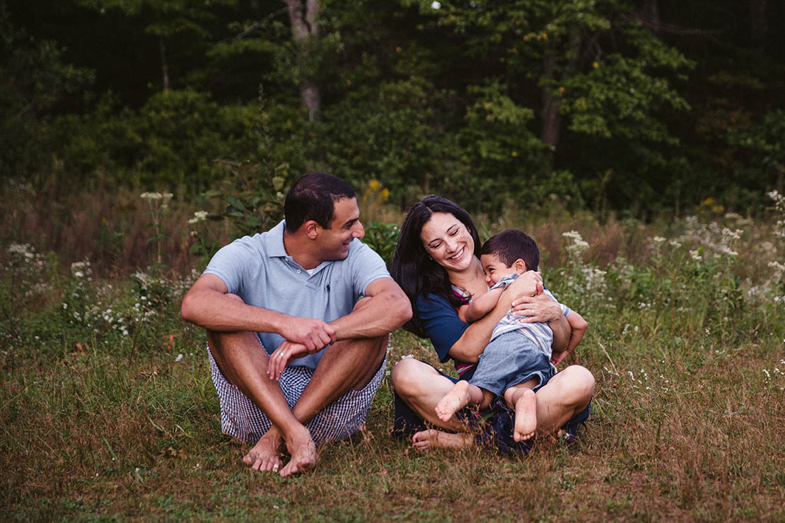 A documentary photograph of a family hanging out at Walden pond during their Boston family session
