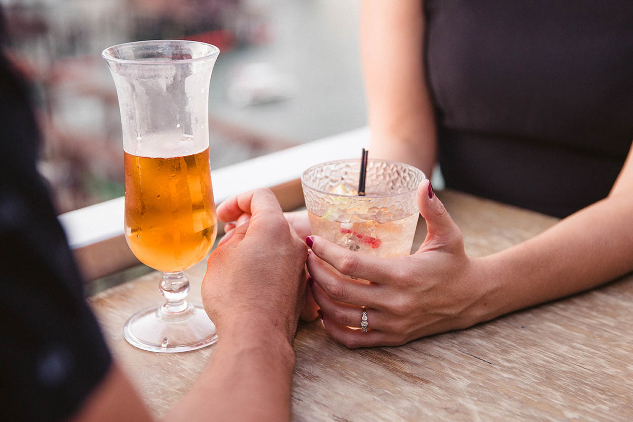 A documentary portrait of a couple hanging out and having a drink in the Seaport District during their Boston engagement session