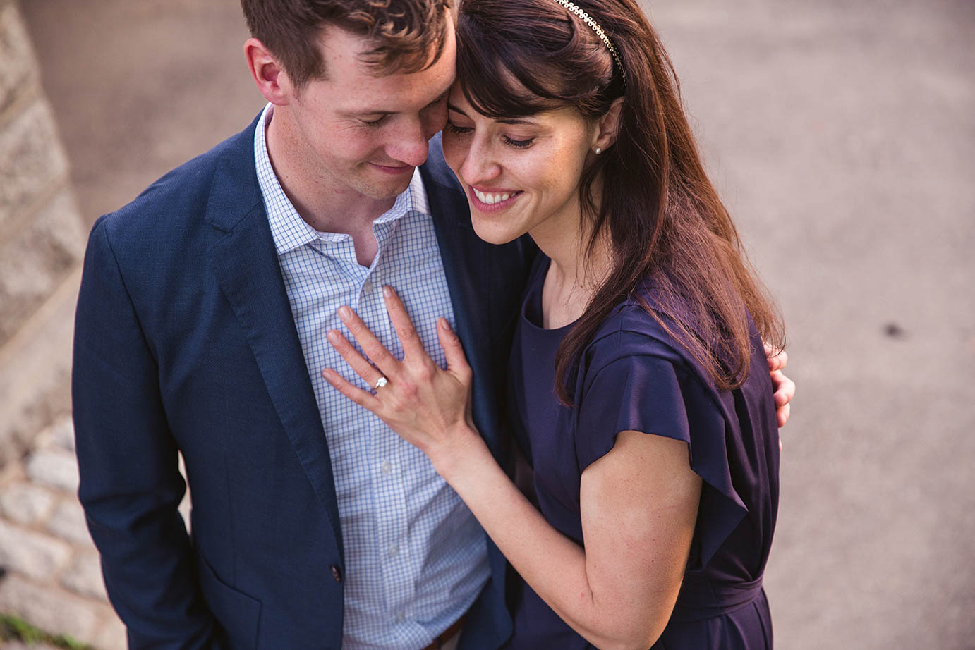 A documentary portrait of a couple hugging at the Public Gardens during their Boston engagement session