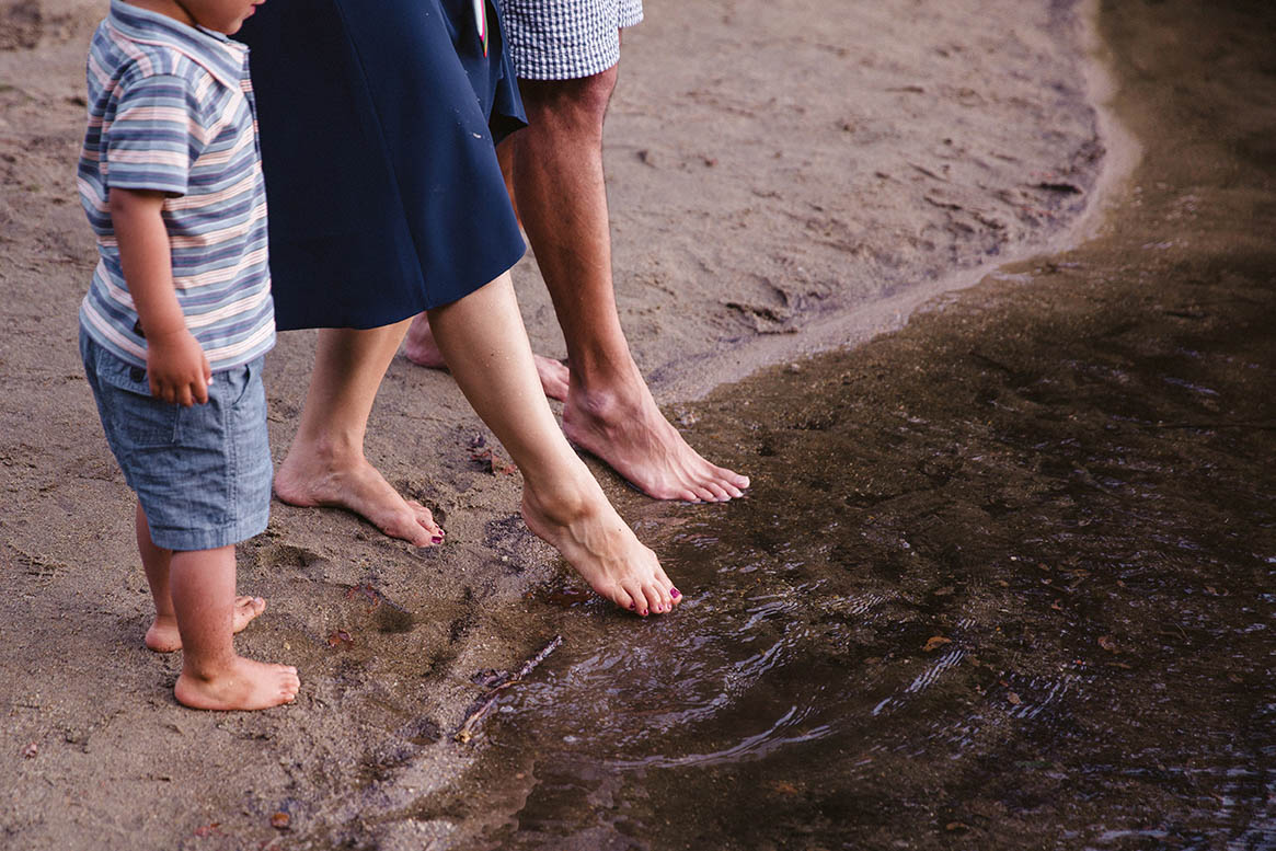 A documentary photograph of a family hanging out at Walden pond during their Boston family session