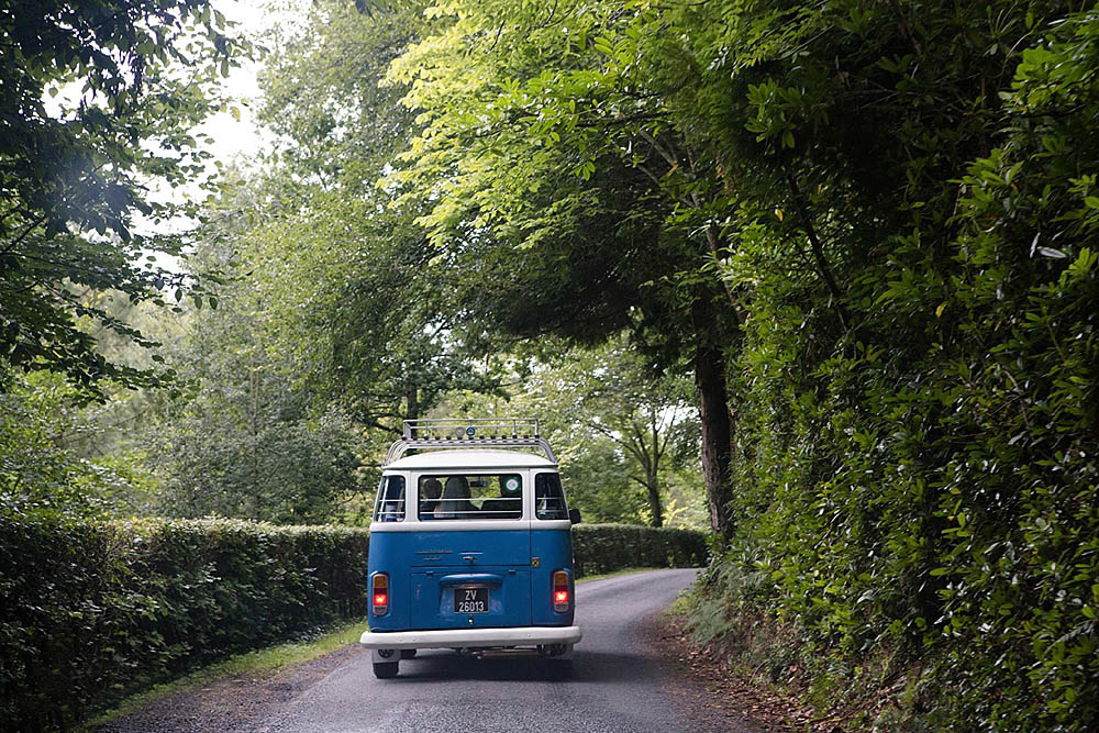 A documentary photograph of a wedding VW Bus driving to the Boston wedding reception
