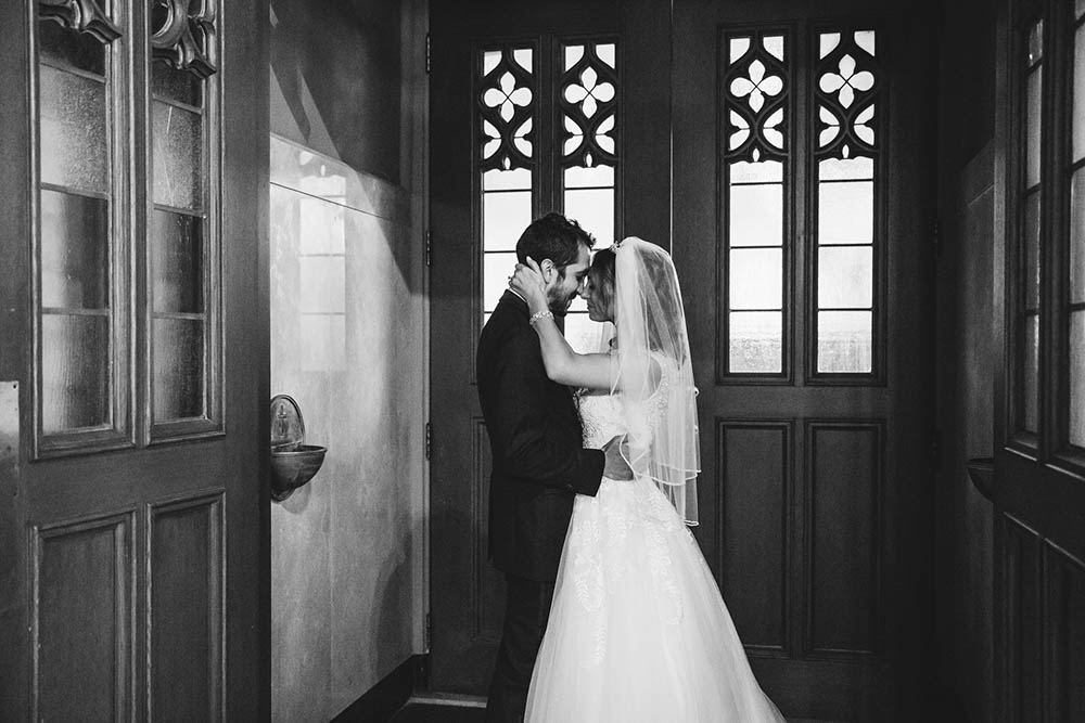 A documentary photograph of a bride and groom sharing an initiate moment after they were married at their Boston Wedding