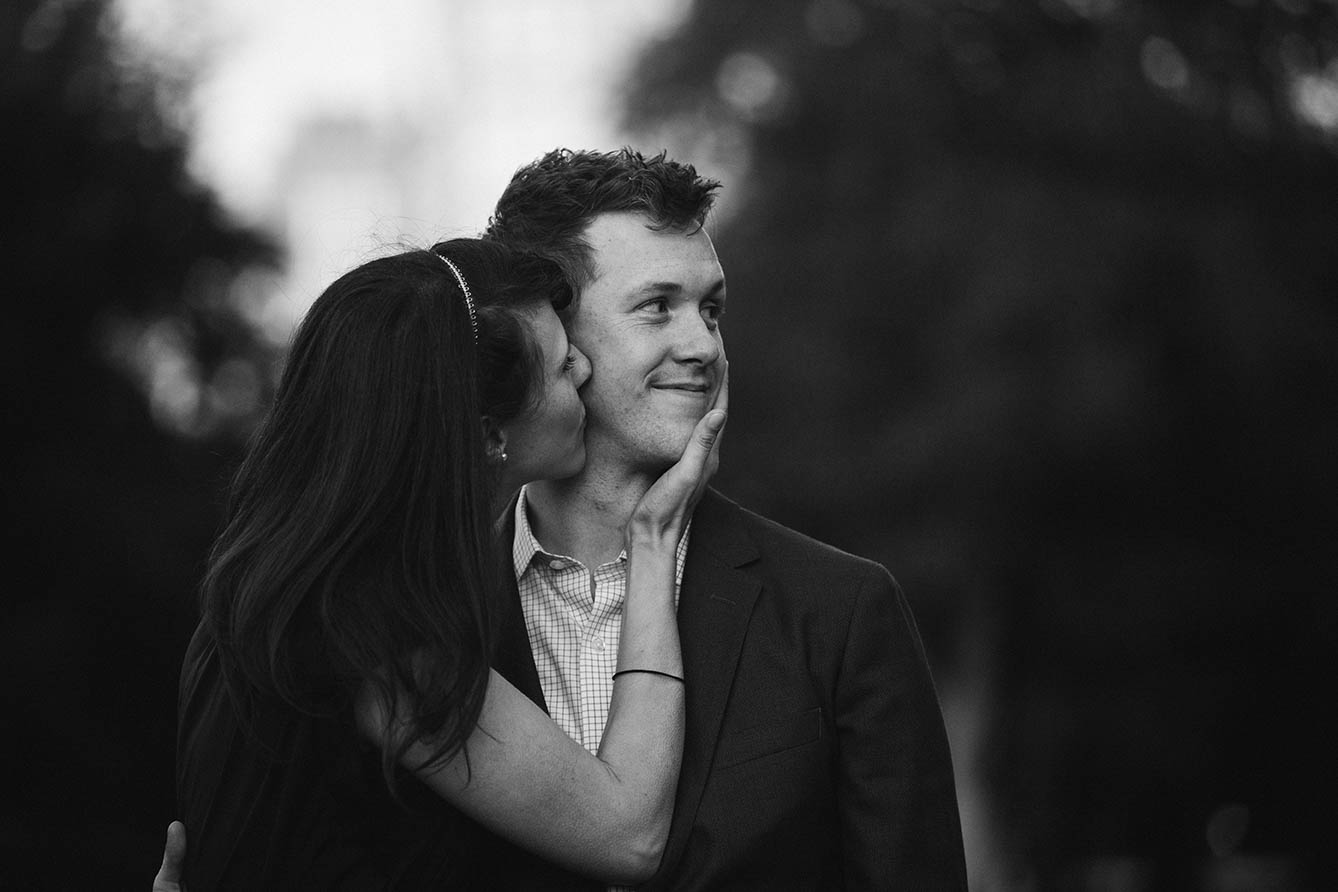 A documentary portrait of a couple kissing at the Public Gardens during their Boston engagement session